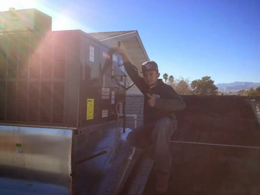 HVAC technician performing HVAC Inspection on a rooftop unit in Flowing Wells